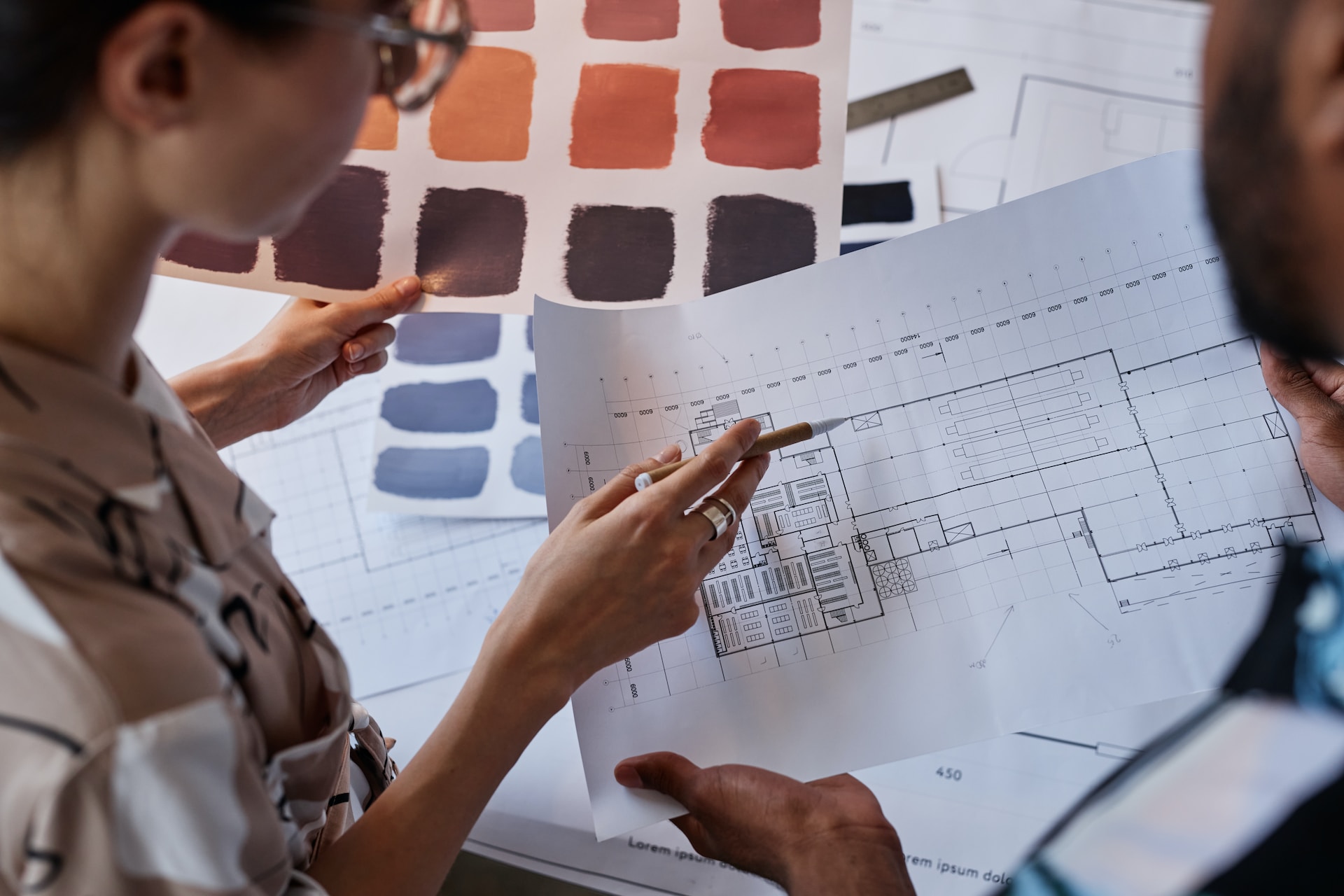 man and woman working on a floor plan